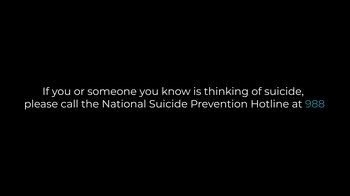 Movie still from “Josh Johnson: Up Here Killing Myself” (2023), directed by Jacob Menache – A black and white image of a suicide prevention message; Extreme Wide shot, Low angle