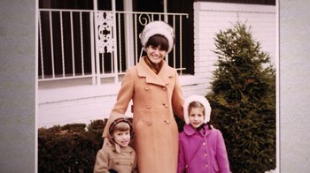 Movie still from “Judy Blume Forever” (2023), directed by Leah Wolchok – A woman and two young girls standing in front of a house; Medium shot, High angle