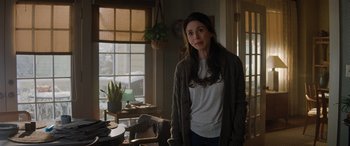 Movie still from “Jumanji: The Next Level” (2019), directed by Jake Kasdan – A woman standing in front of a window in a room; Medium shot, Over the shoulder angle