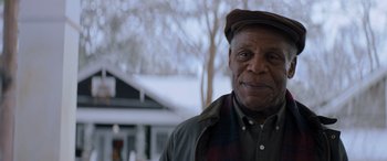 Movie still from “Jumanji: The Next Level” (2019), directed by Jake Kasdan – An older man wearing a hat and a jacket; Close Up shot, Low angle