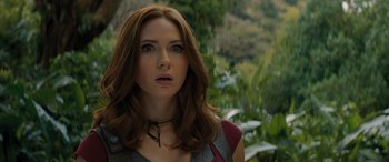 Movie still from “Jumanji: The Next Level” (2019), directed by Jake Kasdan – A person with long brown hair; Close Up shot, Over the shoulder angle