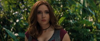 Movie still from “Jumanji: The Next Level” (2019), directed by Jake Kasdan – A beautiful woman with long brown hair wearing a necklace; Close Up shot, Over the shoulder angle