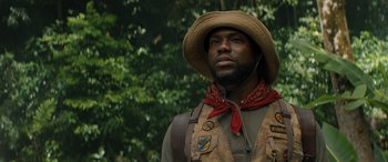Movie still from “Jumanji: The Next Level” (2019), directed by Jake Kasdan – A man wearing a cowboy hat and a vest; Close Up shot, Low angle