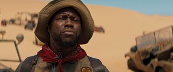 Movie still from “Jumanji: The Next Level” (2019), directed by Jake Kasdan – A person wearing a cowboy hat; Close Up shot, Low angle