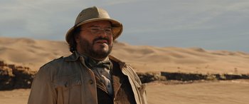 Movie still from “Jumanji: The Next Level” (2019), directed by Jake Kasdan – A man with a hat and a beard standing in the desert; Close Up shot, Low angle