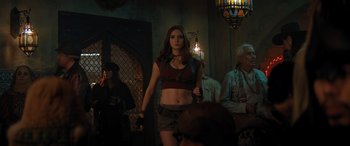Movie still from “Jumanji: The Next Level” (2019), directed by Jake Kasdan – A woman is standing in front of a group of people; Medium shot, Over the shoulder angle