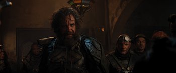 Movie still from “Jumanji: The Next Level” (2019), directed by Jake Kasdan – A man with long hair and a beard standing next to another man with long hair; Medium shot, Low angle