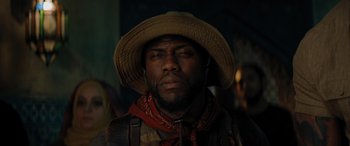 Movie still from “Jumanji: The Next Level” (2019), directed by Jake Kasdan – A person wearing a cowboy hat; Close Up shot, Low angle