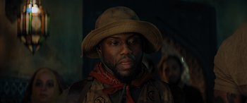 Movie still from “Jumanji: The Next Level” (2019), directed by Jake Kasdan – A person wearing a hat; Close Up shot, Low angle