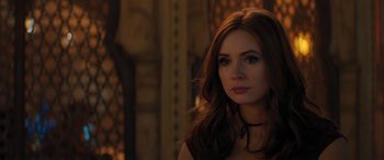 Movie still from “Jumanji: The Next Level” (2019), directed by Jake Kasdan – A beautiful young woman with long red hair wearing a necklace; Close Up shot, Over the shoulder angle