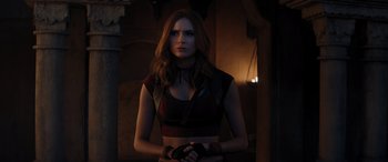 Movie still from “Jumanji: The Next Level” (2019), directed by Jake Kasdan – A woman standing in the dark wearing a red top; Medium shot, Over the shoulder angle