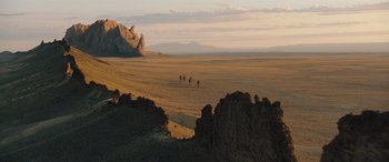 Movie still from “Jumanji: The Next Level” (2019), directed by Jake Kasdan – A group of people riding horses across a desert; Extreme Wide shot, High angle