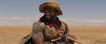 Movie still from “Jumanji: The Next Level” (2019), directed by Jake Kasdan – A man with a beard and a cowboy hat; Close Up shot, Low angle