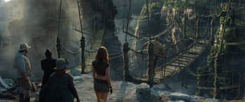 Movie still from “Jumanji: The Next Level” (2019), directed by Jake Kasdan – A woman and a man walking across a bridge; Wide shot, High angle