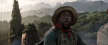 Movie still from “Jumanji: The Next Level” (2019), directed by Jake Kasdan – A man in a cowboy hat is looking surprised; Close Up shot, Low angle