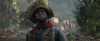Movie still from “Jumanji: The Next Level” (2019), directed by Jake Kasdan – A man with a beard wearing a cowboy hat; Close Up shot, Low angle