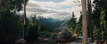 Movie still from “Jumanji: The Next Level” (2019), directed by Jake Kasdan – A person sitting on a rock in the middle of a valley; Extreme Wide shot, Low angle