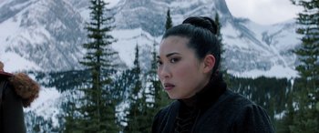 Movie still from “Jumanji: The Next Level” (2019), directed by Jake Kasdan – A woman with a black coat and a black hat; Close Up shot, Over the shoulder angle