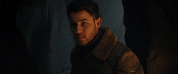 Movie still from “Jumanji: The Next Level” (2019), directed by Jake Kasdan – A man wearing a leather jacket and a fur collar; Close Up shot, Over the shoulder angle