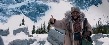 Movie still from “Jumanji: The Next Level” (2019), directed by Jake Kasdan – A man in a parka is pointing to the sky; Medium shot, Low angle