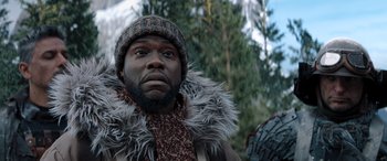 Movie still from “Jumanji: The Next Level” (2019), directed by Jake Kasdan – A person wearing a jacket and a hat; Close Up shot, Low angle