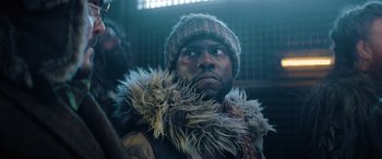 Movie still from “Jumanji: The Next Level” (2019), directed by Jake Kasdan – A person wearing a jacket and a hat; Close Up shot, Low angle