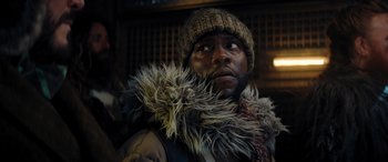Movie still from “Jumanji: The Next Level” (2019), directed by Jake Kasdan – A man wearing a hat and a fur coat; Close Up shot, Low angle