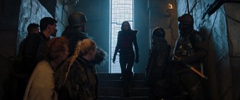 Movie still from “Jumanji: The Next Level” (2019), directed by Jake Kasdan – A woman walking down a set of stairs; Medium shot, Over the shoulder angle