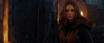 Movie still from “Jumanji: The Next Level” (2019), directed by Jake Kasdan – A woman with long red hair standing next to a building; Close Up shot, Over the shoulder angle
