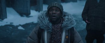 Movie still from “Jumanji: The Next Level” (2019), directed by Jake Kasdan – A man in a winter coat and a hat and scarf; Close Up shot, Low angle
