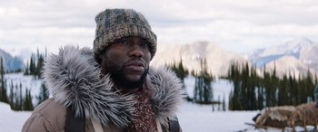 Movie still from “Jumanji: The Next Level” (2019), directed by Jake Kasdan – A man in a fur hat and a jacket; Close Up shot, Low angle