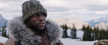 Movie still from “Jumanji: The Next Level” (2019), directed by Jake Kasdan – A person wearing a jacket and a hat; Close Up shot, Low angle