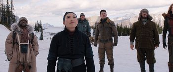 Movie still from “Jumanji: The Next Level” (2019), directed by Jake Kasdan – Three people standing in the snow on top of a hill; Medium shot, Over the shoulder angle