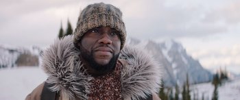 Movie still from “Jumanji: The Next Level” (2019), directed by Jake Kasdan – A person wearing a jacket and a hat; Close Up shot, Low angle