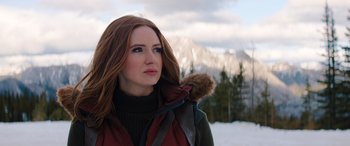 Movie still from “Jumanji: The Next Level” (2019), directed by Jake Kasdan – A woman with red hair wearing a red jacket; Close Up shot, Low angle