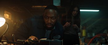 Movie still from “Jumanji: The Next Level” (2019), directed by Jake Kasdan – A man and a woman sitting at a table; Close Up shot, Over the shoulder angle