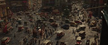 Movie still from “Jungle Cruise” (2021), directed by Jaume Collet-Serra – An aerial view of a busy city street with cars and people; Extreme Wide shot, High angle