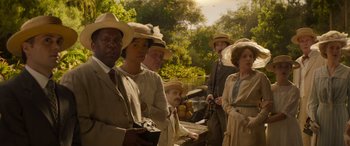 Movie still from “Jungle Cruise” (2021), directed by Jaume Collet-Serra – A group of people standing next to a body of water; Medium shot, High angle