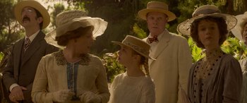 Movie still from “Jungle Cruise” (2021), directed by Jaume Collet-Serra – A man and a woman and a little girl wearing hats; Medium shot, Over the shoulder angle
