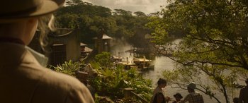 Movie still from “Jungle Cruise” (2021), directed by Jaume Collet-Serra – A group of people standing next to a body of water; Extreme Wide shot, High angle