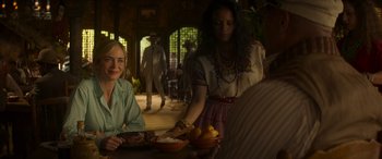 Movie still from “Jungle Cruise” (2021), directed by Jaume Collet-Serra – Two women sitting at a table with a bowl of fruit; Medium shot, Over the shoulder angle