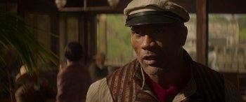 Movie still from “Jungle Cruise” (2021), directed by Jaume Collet-Serra – A person wearing a hat; Close Up shot, Over the shoulder angle