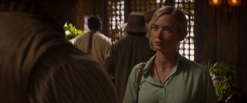 Movie still from “Jungle Cruise” (2021), directed by Jaume Collet-Serra – A woman standing in front of a group of people; Close Up shot, Over the shoulder angle