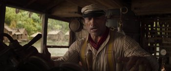 Movie still from “Jungle Cruise” (2021), directed by Jaume Collet-Serra – A man in a hat driving a truck; Close Up shot, Low angle