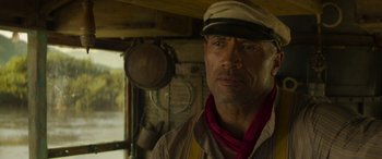 Movie still from “Jungle Cruise” (2021), directed by Jaume Collet-Serra – A person wearing a hat; Close Up shot, Over the shoulder angle