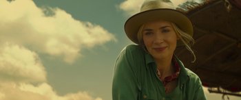 Movie still from “Jungle Cruise” (2021), directed by Jaume Collet-Serra – A woman wearing a hat is smiling for the camera; Close Up shot, Low angle