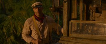 Movie still from “Jungle Cruise” (2021), directed by Jaume Collet-Serra – A man wearing a white hat and holding a rope; Medium shot, Low angle