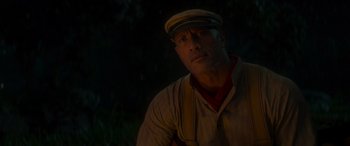 Movie still from “Jungle Cruise” (2021), directed by Jaume Collet-Serra – A man wearing a hat and a striped shirt; Close Up shot, Over the shoulder angle