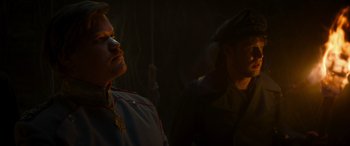 Movie still from “Jungle Cruise” (2021), directed by Jaume Collet-Serra – Two men in military uniforms in a dark room; Close Up shot, Over the shoulder angle