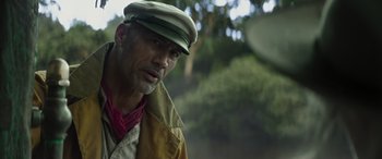 Movie still from “Jungle Cruise” (2021), directed by Jaume Collet-Serra – A person wearing a hat; Close Up shot, Over the shoulder angle